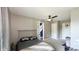 Bedroom with ceiling fan, a bed and closet and hallway view of front door featuring a blue accent wall at 80 E College Ave, Martinsville, IN 46151
