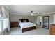 Spacious primary bedroom featuring a queen-sized bed, ceiling fan, and a large window at 80 E College Ave, Martinsville, IN 46151
