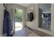Welcoming entryway features a coat rack, brick floors, and a view into the adjacent living area at 80 E College Ave, Martinsville, IN 46151