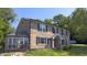 Two-story brick home featuring a sunroom addition and well-manicured lawn at 80 E College Ave, Martinsville, IN 46151