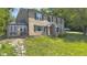 Inviting two-story brick home with a bay window and landscaped yard on a sunny day at 80 E College Ave, Martinsville, IN 46151
