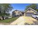 Charming brick home with a well-manicured lawn and a driveway leading to the garage at 80 E College Ave, Martinsville, IN 46151