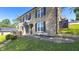 Brick home exterior showcasing a cozy seating area and well-maintained lawn at 80 E College Ave, Martinsville, IN 46151