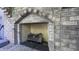 Close-up of stone fireplace with wood burning logs at 80 E College Ave, Martinsville, IN 46151