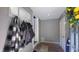 A bright, welcoming entryway with brick flooring and a coat rack with mirror at 80 E College Ave, Martinsville, IN 46151