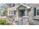 Charming brick front exterior with covered porch and professionally landscaped yard at 80 E College Ave, Martinsville, IN 46151