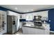 Bright kitchen with white cabinets, stainless steel appliances, and an island with metal countertop at 80 E College Ave, Martinsville, IN 46151
