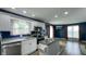 Modern kitchen features white cabinets, stainless appliances, and a view into the brightly lit living area at 80 E College Ave, Martinsville, IN 46151