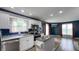 Kitchen featuring white cabinets, stainless steel appliances, and an island with metal countertop at 80 E College Ave, Martinsville, IN 46151