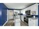Bright kitchen features white cabinets, stainless steel appliances, and wood-look flooring at 80 E College Ave, Martinsville, IN 46151