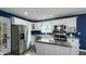 Modern kitchen with white cabinets, stainless steel appliances, and an island at 80 E College Ave, Martinsville, IN 46151