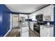 Kitchen featuring white cabinets, stainless steel appliances, and a functional island with metal countertop at 80 E College Ave, Martinsville, IN 46151