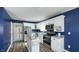 Bright kitchen features stainless steel appliances, white cabinetry, and a functional island with counter seating at 80 E College Ave, Martinsville, IN 46151