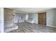Spacious living room with a brick fireplace, hardwood flooring, and a sliding barn door at 80 E College Ave, Martinsville, IN 46151