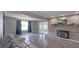Spacious living room featuring a cozy brick fireplace and adjacent sunroom with glass french doors at 80 E College Ave, Martinsville, IN 46151