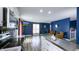An open-concept living area with white cabinets and stainless appliances, flowing into the living room at 80 E College Ave, Martinsville, IN 46151