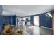 Open living area with adjacent kitchen, hard wood floors, and leather seating with plenty of light at 80 E College Ave, Martinsville, IN 46151