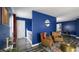 Comfortable living room with blue walls, hardwood floors, and cozy brown leather armchairs at 80 E College Ave, Martinsville, IN 46151