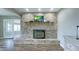Bright living room featuring a brick fireplace, hardwood floors, and open floor plan at 80 E College Ave, Martinsville, IN 46151