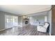 Spacious living room with hardwood floors, fireplace, and access to sunroom at 80 E College Ave, Martinsville, IN 46151