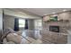 Spacious living room with a brick fireplace, large window, and hardwood flooring at 80 E College Ave, Martinsville, IN 46151