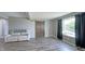 Living room with barn door and large window with curtains for natural light and privacy at 80 E College Ave, Martinsville, IN 46151