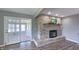 Bright living room with brick fireplace, hardwood floors, and an adjoining sunroom at 80 E College Ave, Martinsville, IN 46151