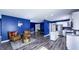 Open-concept living space with stylish seating, wood floors, leading to the kitchen and dining area at 80 E College Ave, Martinsville, IN 46151
