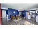 Open-concept living space with stylish seating, wood floors, leading to the kitchen and dining area at 80 E College Ave, Martinsville, IN 46151