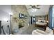Bright main bedroom featuring brick fireplace, ceiling fan, and ensuite bathroom at 80 E College Ave, Martinsville, IN 46151