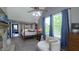 Bright main bedroom features blue curtains, vaulted ceiling, and a four-poster bed at 80 E College Ave, Martinsville, IN 46151