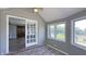Bright sunroom with brick floor, white french doors, and many windows for a cheerful atmosphere at 80 E College Ave, Martinsville, IN 46151