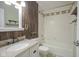 Bathroom with a granite vanity, shower/tub combo, wood accent wall and wood shelf at 858 Cedar Wood, Carmel, IN 46032