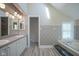 Bright primary bathroom with double sinks, a soaking tub, patterned wallpaper, and a skylight at 858 Cedar Wood, Carmel, IN 46032