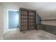 Bonus room with custom blue walls, carpeting, and built in shelving and cabinets at 858 Cedar Wood, Carmel, IN 46032
