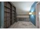 Bonus room with custom blue walls, carpeting, and built in shelving and cabinets at 858 Cedar Wood, Carmel, IN 46032