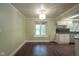 Open dining area adjacent to the kitchen with hardwood floors, chandelier, and bright window at 858 Cedar Wood, Carmel, IN 46032