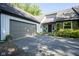 Charming home exterior with a stone accent wall, two car garage and a paved driveway at 858 Cedar Wood, Carmel, IN 46032