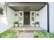 Inviting front porch with potted plants, a dark wood door, and neutral siding at 858 Cedar Wood, Carmel, IN 46032
