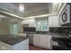 Charming kitchen featuring granite countertops, stainless steel appliances, and black diamond patterned backsplash at 858 Cedar Wood, Carmel, IN 46032