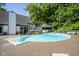 An in-ground pool offers a gazebo, deck, and lounge chairs for luxurious outdoor living with mature trees surrounding at 858 Cedar Wood, Carmel, IN 46032