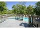 A stunning pool with a wood deck and secure railing is surrounded by lush trees and offers the perfect backyard oasis at 858 Cedar Wood, Carmel, IN 46032