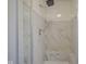 Modern bathroom shower featuring white marble tiling, a rainfall showerhead, and built in bench at 858 Cedar Wood, Carmel, IN 46032