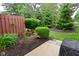 Beautiful backyard featuring flower beds, lush green bushes, mulched beds, and a patio at 9154 Sea Oats Dr, Indianapolis, IN 46250