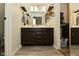 Modern bathroom with custom floating shelves, a vanity with cabinets and a double mirror reflecting the room at 9154 Sea Oats Dr, Indianapolis, IN 46250