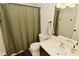 Bright bathroom featuring a standard white toilet and a shower with an olive green curtain and bronze hardware at 9154 Sea Oats Dr, Indianapolis, IN 46250