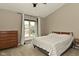 Relaxing bedroom with a high ceiling, a plush bed, and a large window offering natural light and neighborhood views at 9154 Sea Oats Dr, Indianapolis, IN 46250