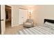 Cozy bedroom featuring a comfortable bed, chair, soft carpet, and ample closet space at 9154 Sea Oats Dr, Indianapolis, IN 46250