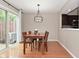 The dining room features hardwood floors, a pendant light and a view into the kitchen at 9154 Sea Oats Dr, Indianapolis, IN 46250