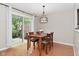 Bright dining room with wood table, chandelier lighting, and sliding door to a backyard view at 9154 Sea Oats Dr, Indianapolis, IN 46250